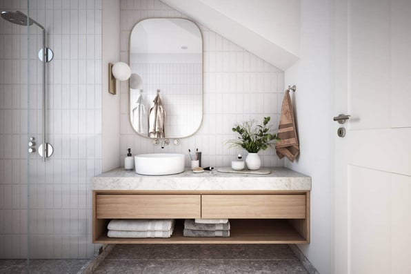 A beautiful, curved mirror in a newly remodeled bathroom, increasing the use of functional space.