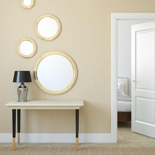 Different sizes of round accent mirrors brighten a space.