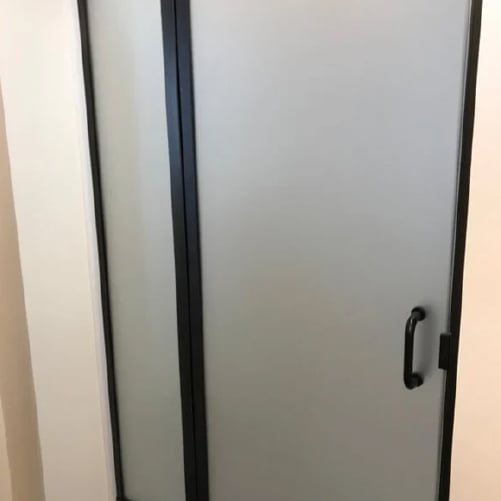 Pattern glass shower door with black framing