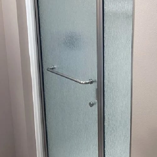 Pattern glass shower door with silver hardware